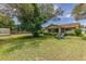 Expansive backyard with lush green grass, storage shed, and screened patio at 5078 Kenmore St, Spring Hill, FL 34608
