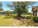 Inviting backyard with mature trees, fire pit, and comfortable seating, perfect for outdoor relaxation at 5078 Kenmore St, Spring Hill, FL 34608