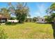 Expansive backyard featuring a shed, lush green grass, and mature trees at 5078 Kenmore St, Spring Hill, FL 34608
