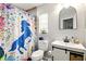 Bathroom featuring modern fixtures, a decorative mirror, and a colorful shower curtain at 5078 Kenmore St, Spring Hill, FL 34608