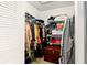 Organized walk-in closet with shelving and hanging space for clothing and accessories at 5078 Kenmore St, Spring Hill, FL 34608