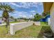 View of the front yard featuring a decorative wall and a mature palm tree at 5078 Kenmore St, Spring Hill, FL 34608