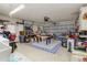 Spacious garage with a foosball table, storage shelves, and a roll-up door at 5078 Kenmore St, Spring Hill, FL 34608