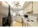 Kitchen featuring tile floor, stainless steel appliances, white cabinets and a ceiling fan at 5078 Kenmore St, Spring Hill, FL 34608