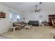 Inviting living room with a vaulted ceiling, ceiling fan, and comfortable sofas at 5078 Kenmore St, Spring Hill, FL 34608