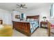 Spacious main bedroom with a king-size bed, ceiling fan, and bright natural light at 5078 Kenmore St, Spring Hill, FL 34608