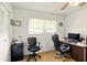 Home office with two chairs, a large desk, and natural light from a window with blinds at 5078 Kenmore St, Spring Hill, FL 34608