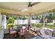 Cozy sunroom featuring a glass table, comfortable seating, and views of the outdoors at 5078 Kenmore St, Spring Hill, FL 34608