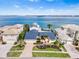 Gorgeous aerial view of a waterfront home with a blue roof, lush landscaping, and serene ocean views at 849 Harbor Is, Clearwater Beach, FL 33767