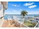 Balcony with outdoor furniture and a view of the waterfront, a palm tree, and clear skies at 849 Harbor Is, Clearwater Beach, FL 33767
