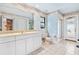 Bathroom featuring white cabinetry, a large mirror, tiled floors, and a shower with an exterior door at 849 Harbor Is, Clearwater Beach, FL 33767