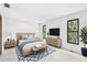 Bright bedroom with neutral decor, hardwood floors, and large windows offering ample natural light at 849 Harbor Is, Clearwater Beach, FL 33767