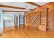Living room showcasing custom built-in shelves, wood paneling, exposed beams, and hardwood floors at 849 Harbor Is, Clearwater Beach, FL 33767