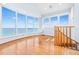 Bright living room with expansive windows and hardwood flooring showcasing the beautiful waterfront view at 849 Harbor Is, Clearwater Beach, FL 33767