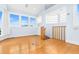 Bright living room with hardwood floors, large windows, and staircase access at 849 Harbor Is, Clearwater Beach, FL 33767