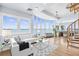 Bright and airy living room featuring a wall of windows and views of the water and access to a spiral staircase at 849 Harbor Is, Clearwater Beach, FL 33767