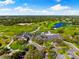 Aerial shot of the clubhouse with a lake and lush golf course at 2546 Tom Morris Dr, Sarasota, FL 34240