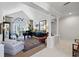 Elegant living room featuring a grand piano, columns, and lots of natural light at 2546 Tom Morris Dr, Sarasota, FL 34240