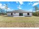 This home features a spacious backyard with a gray exterior at 14183 English Sparrow Rd, Weeki Wachee, FL 34614