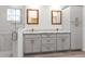 Bathroom featuring a double sink vanity with white marble counters, a shower, and modern cabinets at 14183 English Sparrow Rd, Weeki Wachee, FL 34614