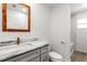 Bathroom featuring a sink with marble countertop, vanity with brushed gold pulls and a toilet at 14183 English Sparrow Rd, Weeki Wachee, FL 34614