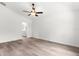 Bedroom featuring an en suite bathroom, ceiling fan, and wood-look flooring creating a stylish space at 14183 English Sparrow Rd, Weeki Wachee, FL 34614