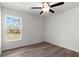 A simple, bright bedroom with a ceiling fan and view to the outdoors at 14183 English Sparrow Rd, Weeki Wachee, FL 34614
