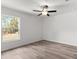 Bright bedroom with natural light, ceiling fan, and wood-look flooring creating a warm, inviting space at 14183 English Sparrow Rd, Weeki Wachee, FL 34614