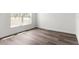 Well-lit bedroom showcasing new wood flooring and a window for natural light at 14183 English Sparrow Rd, Weeki Wachee, FL 34614