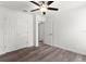 A simple, bright bedroom with a ceiling fan, closet, and an open doorway at 14183 English Sparrow Rd, Weeki Wachee, FL 34614