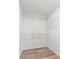 Walk-in closet featuring wood-look flooring and white wire shelving at 14183 English Sparrow Rd, Weeki Wachee, FL 34614