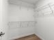 Walk-in closet featuring wood-look flooring, shelving, and ample storage space at 14183 English Sparrow Rd, Weeki Wachee, FL 34614
