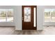 Modern home foyer featuring a stained-glass front door, hardwood flooring and large windows at 14183 English Sparrow Rd, Weeki Wachee, FL 34614