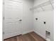 A clean laundry room with wood-look flooring and a wire rack for storage at 14183 English Sparrow Rd, Weeki Wachee, FL 34614