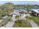 Waterfront home with palm trees, a brick-paved driveway, and canal access, located in a desirable coastal community at 193 Mar St, St Pete Beach, FL 33706