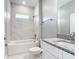 Elegant bathroom with marble-tiled shower-tub and granite countertop vanity at 2576 Pecan St, North Port, FL 34287