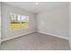 Carpeted bedroom with a window view at 2576 Pecan St, North Port, FL 34287