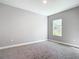 Neutral bedroom featuring carpet, a window with natural light, and electrical outlets at 2576 Pecan St, North Port, FL 34287