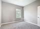 Bright bedroom with carpet, a window overlooking the outdoors, and neutral wall paint at 2576 Pecan St, North Port, FL 34287