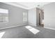 Spacious bedroom with plush carpeting, two windows, and ensuite bathroom access at 2576 Pecan St, North Port, FL 34287