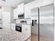 Stylish kitchen with stainless steel appliances, granite countertops and white subway tile backsplash at 2576 Pecan St, North Port, FL 34287