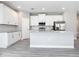 Modern kitchen featuring white cabinets, stainless steel appliances, and an island with granite countertops at 2576 Pecan St, North Port, FL 34287