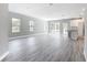 Bright open-concept living room featuring hard surface floors and access to a kitchen at 2576 Pecan St, North Port, FL 34287