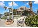 Serene backyard oasis with a fire pit, Adirondack chairs, lush greenery, and water access at 4446 Bahama Dr, Hernando Beach, FL 34607