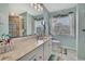 Bathroom featuring a large vanity, ample lighting, decorative mirror, and a window at 4446 Bahama Dr, Hernando Beach, FL 34607