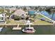 Waterfront home featuring tropical landscaping, a private dock, and easy access to the canal at 4446 Bahama Dr, Hernando Beach, FL 34607