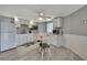 Well-lit kitchen with white cabinetry, modern appliances, and a cozy dining area at 4446 Bahama Dr, Hernando Beach, FL 34607