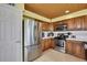 Nicely arranged kitchen featuring stainless steel appliances, wood cabinetry, and tile flooring at 4446 Bahama Dr, Hernando Beach, FL 34607