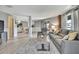 Bright and open living area flows into the kitchen, featuring stylish furnishings and wood flooring at 4446 Bahama Dr, Hernando Beach, FL 34607