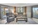 Cozy living room with a comfortable sofa, accent pillows, wood floors, and natural light at 4446 Bahama Dr, Hernando Beach, FL 34607